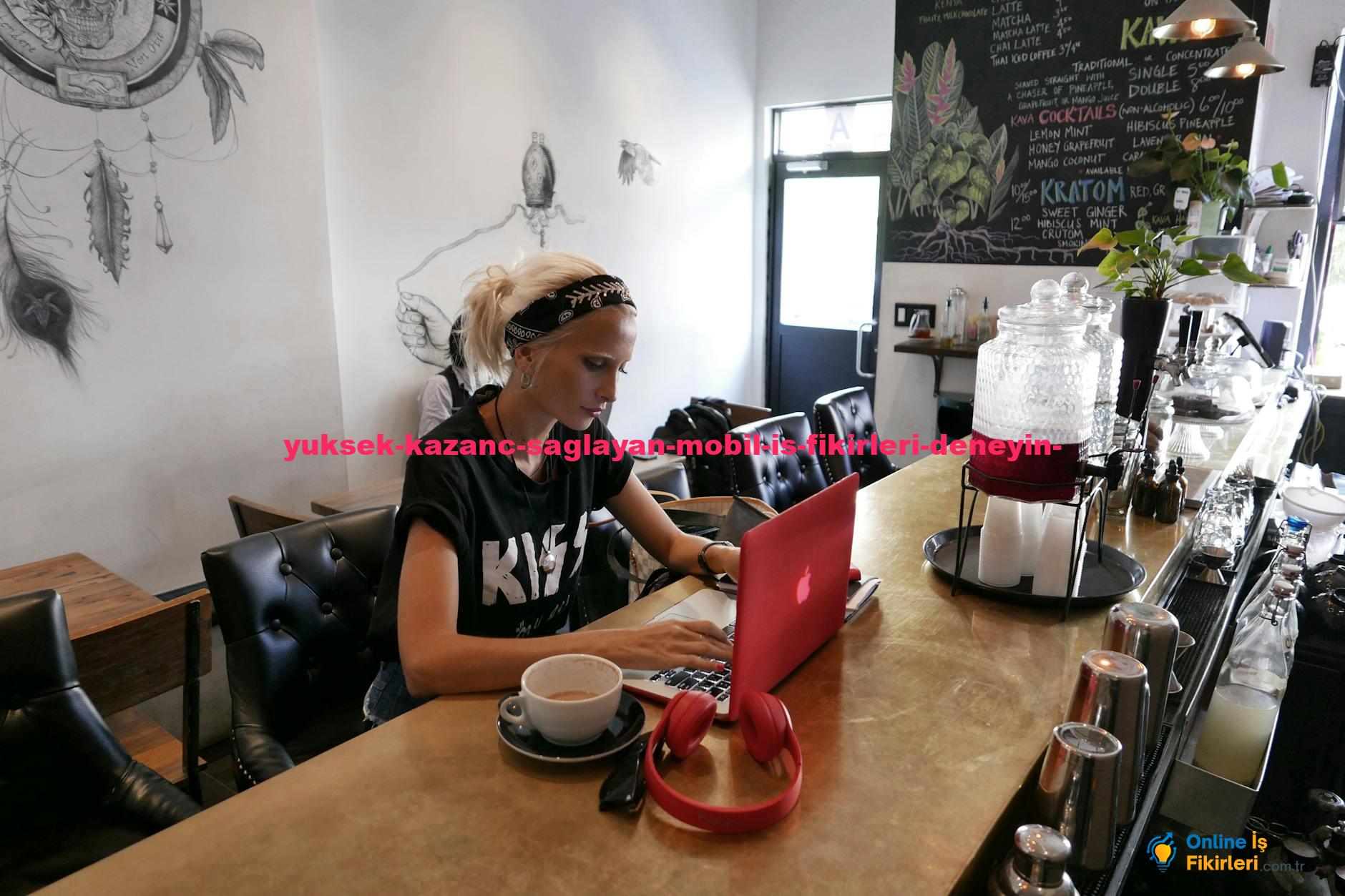 Woman engaged in blogging with a laptop at a trendy cafe in Brooklyn, NY.