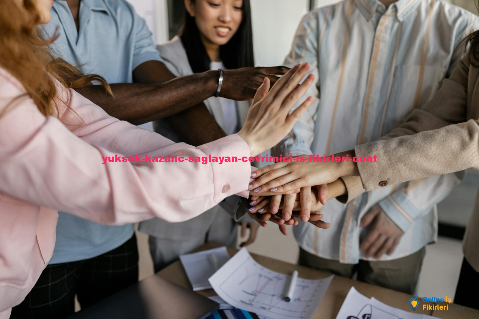 Diverse team members putting hands together in an office, symbolizing collaboration and unity.