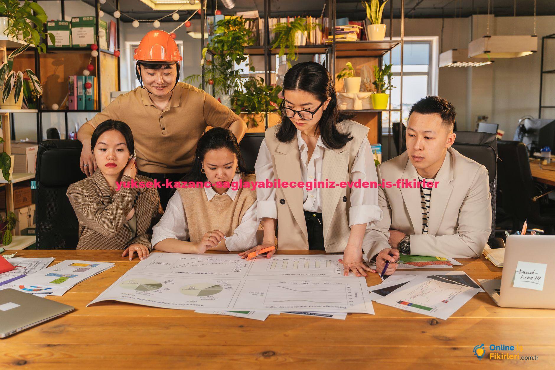 Diverse team collaborating on a project at a desk in a modern office environment with charts and plans.